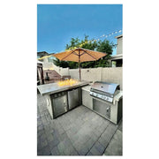 Kokomo Grills Baja/Fire L-Shaped BBQ Island with fire pit, 4 burner stainless steel grill, outdoor refrigerator, and umbrella shade.