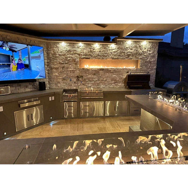 Kokomo Grills Luxury Outdoor Kitchen BBQ Grill Island with stainless steel burners, limestone countertops, fire feature, and storage cabinets.