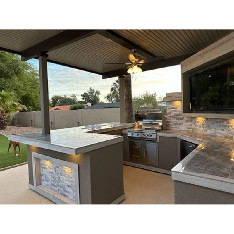 Kokomo Grills Best Outdoor Kitchen Bermuda BBQ Island with 4 burner grill, pergola, stone accents, and oversized TV.