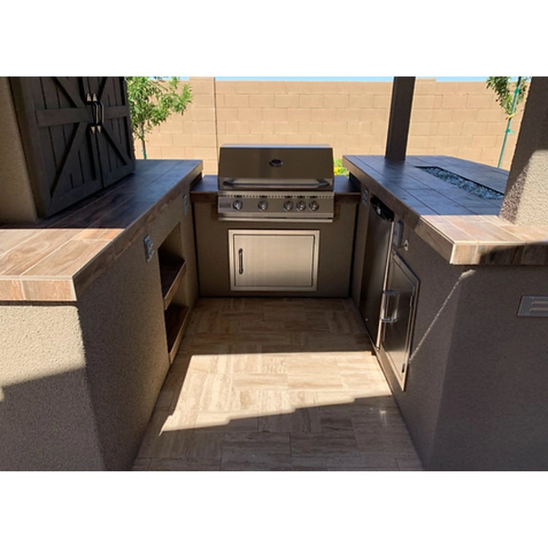 Kokomo Grills Barn Door TV Wall BBQ Island with 4 burner stainless steel grill, storage doors, and tiled countertops in outdoor setup