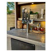 Kokomo Grills Fantasy Island 20'x20' with outdoor kegerator taps, gray tiled countertop, shelving, and ambient lighting.