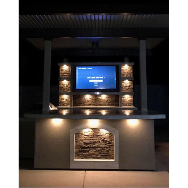 Kokomo Grills St. Croix Outdoor Kitchen with built-in TV, stone back wall, under-counter lighting, and 12x12 patio cover.