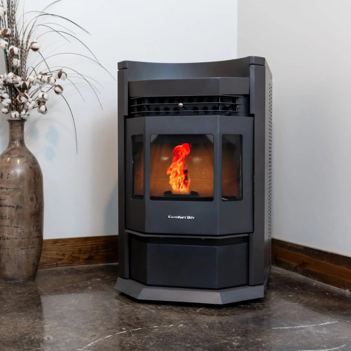 Black pellet stove with visible flames inside, next to a decorative vase on a marble floor.