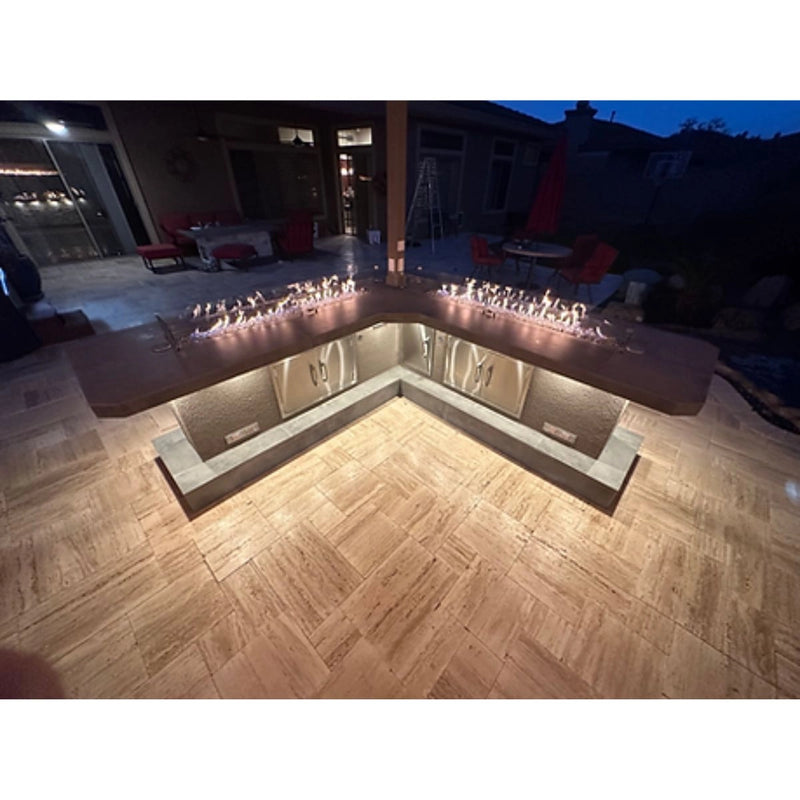 Kokomo Grills Luxury Outdoor Kitchen BBQ Grill Island with stainless steel cabinets, fire feature, and L-shaped quartz countertop.