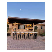 Kokomo Grills Fantasy Island 20'x20' outdoor kitchen with 70" TV, aluminum roof, bar seating, shelves, lighting, and 5-burner grill.