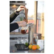 Kokomo Grills Best Outdoor Kitchen Bermuda BBQ Island with stainless steel keg cooler and KoKoMo tap handles pouring beer outdoors.