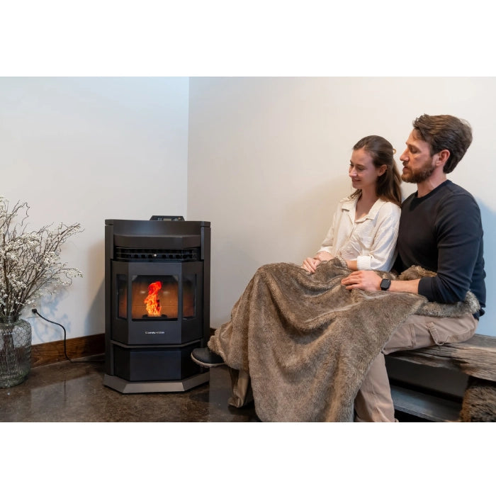 Two people sitting together in front of a pellet stove in a cozy room.