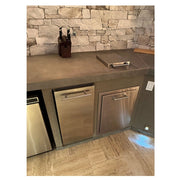 Kokomo Grills Luxury Outdoor Kitchen BBQ Grill Island with stainless steel storage doors, sleek countertop, and stone backsplash.