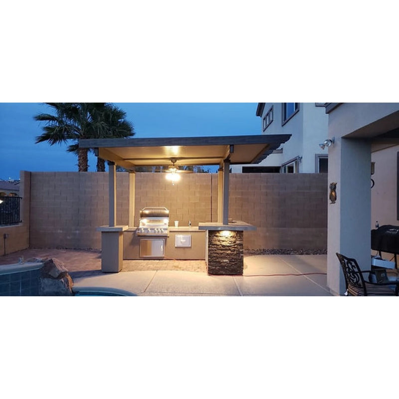Kokomo Grills Aruba BBQ Island with 12' x 12' pergola, 4-burner grill, stone accents, stucco finish, and under-counter lighting.