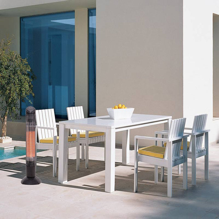 Outdoor dining set with white table and chairs near a poolside area.