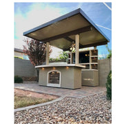 Kokomo Grills St. Croix Outdoor Kitchen with built-in 32" 4-burner BBQ grill, stone back wall, and 12x12 patio cover.