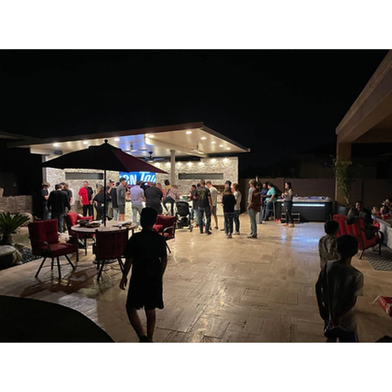 Kokomo Grills Luxury Outdoor Kitchen BBQ Grill Island with stainless steel burners, quartz countertops, and integrated storage in backyard setting.