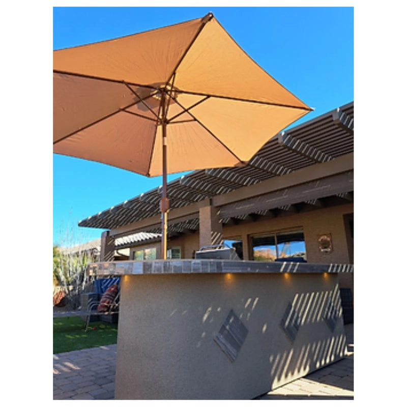 Kokomo Grills Aruba BBQ Island 6' x 9'6" L-shape with Spectrum Brown stucco, tile countertop, under-counter lighting, and raised bar.