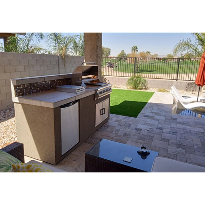 Kokomo Grills Bali 7'6" Island outdoor kitchen with backsplash, 4-burner grill, side burner, fridge, stucco finish, and tile countertop.