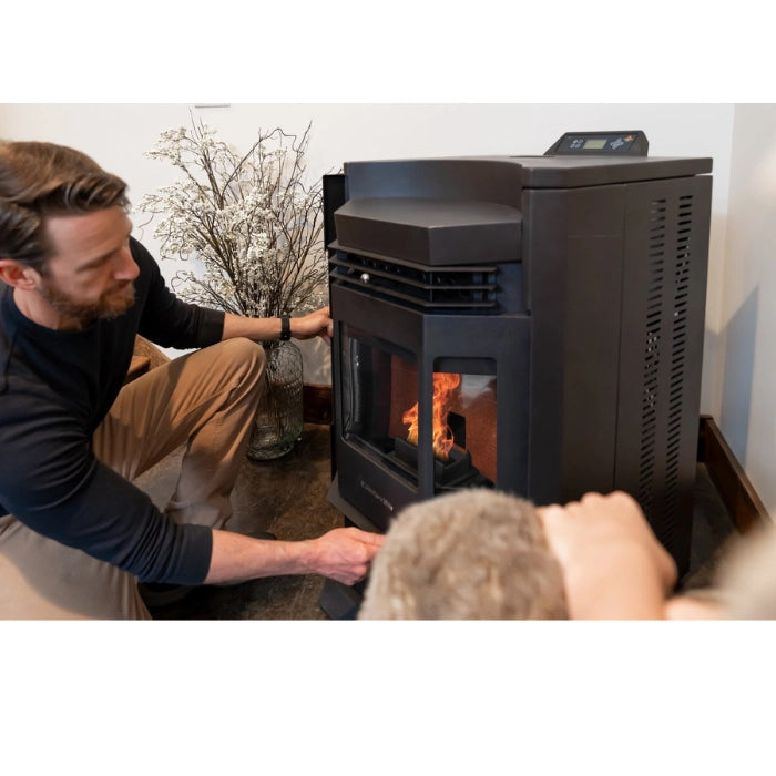 Person interacting with a modern pellet stove in a home setting