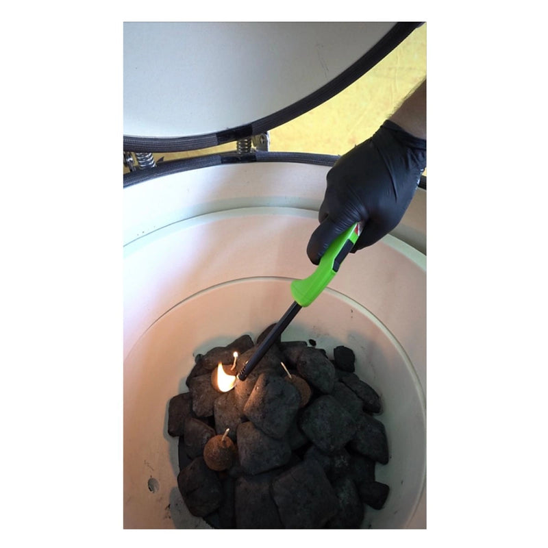 Kokomo Grills 21 Inch Kamado KoKoMo Ceramic BBQ Grill lighting charcoal inside its premium ceramic black body with a green lighter.