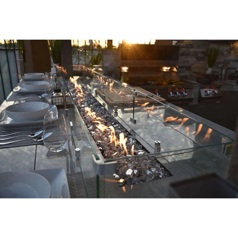 Kokomo Grills Best Outdoor Kitchen Bermuda BBQ Island with built-in fire pit, glass wind guard, and stainless steel burners.