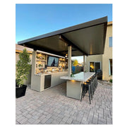 Kokomo Grills Fantasy Island 20'x20' outdoor kitchen with aluminum roof, fan, 20' bar, media wall, and 70" TV.