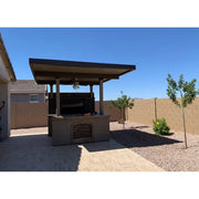 Kokomo Grills Barn Door TV Wall BBQ Island with 4 Burner built-in grill, stone arch, media center, and covered pergola.