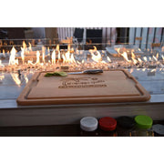 Kokomo Grills Best Outdoor Kitchen Bermuda BBQ Island with wooden cutting board and glass fire pit for stylish grilling ambiance