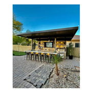 Kokomo Grills Fantasy Island 20'x20' with 70" TV, 5 burner grill, aluminum roof, bar seating, and outdoor lighting.