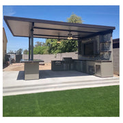 Kokomo Grills Outdoor Kitchen Montego Model BBQ Island with built-in grill, stainless steel storage, and covered patio cooking area