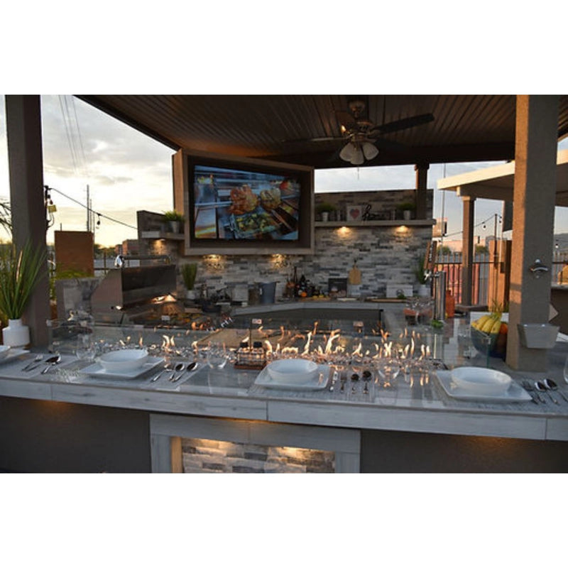 Kokomo Grills Best Outdoor Kitchen Bermuda BBQ Island with 4 burners, fire pit, TV, and stainless steel storage.