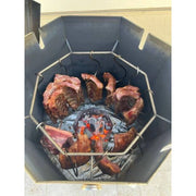 Grill Brothers Barrel Mini stainless steel charcoal grill with 12 hanging hooks cooking meat evenly around central charcoal container.