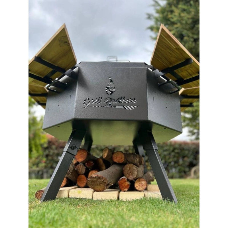 Grill Brothers Grill Stoker with 3mm iron, teak wood supports, dual folding grills, and adjustable legs in cactus gray finish.