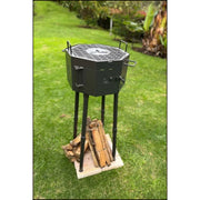 Grill Brothers Grill Travel portable charcoal grill with folding grates, detachable legs, and black stainless steel body on grass.