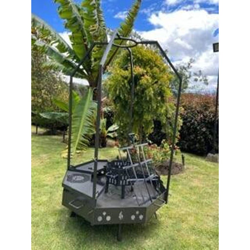Grill Brothers Moster Doumo octagonal outdoor grill with 3mm iron, adjustable cooking heights, and accessories in garden setting.