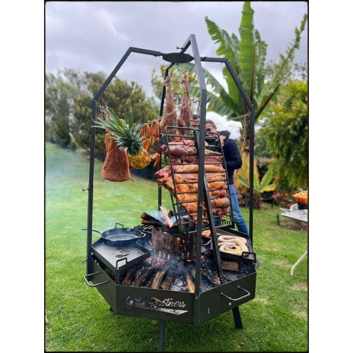Grill Brothers Moster Doumo octagonal Argentine grill with 3mm iron, stainless steel, adjustable stoker, and hanging hooks for versatile cooking.