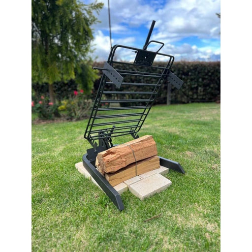 Grill Brothers Stake Medium manufactured iron grill with 3-position adjustable stake system and robust 10.5mm rods on grassy outdoor setting.
