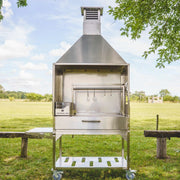 Tagwood BBQ Attachment Built-in Smoke Hood ASH25 stainless steel grill-mounted canopy with smoke vents and hanging hooks outdoors.