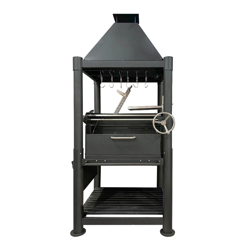 Tagwood BBQ The Beast Argentine Santa Maria grill in black painted steel with height-adjustable grates and peaked roof design.