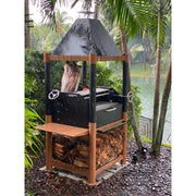 Tagwood BBQ The Beast Argentine Santa Maria Style wood fire gaucho grill with black steel, wood accents, peaked roof, and adjustable grates.
