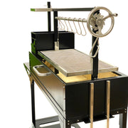 Tagwood BBQ Freestanding Argentine Santa Maria Grill with black steel body, stainless steel grates, and height-adjustable grilling wheel.