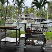 Tagwood BBQ Freestanding Mini Argentine Santa Maria Grill BBQ03SS MINI with stainless steel, adjustable grates, brasero firebox, and peaked roof