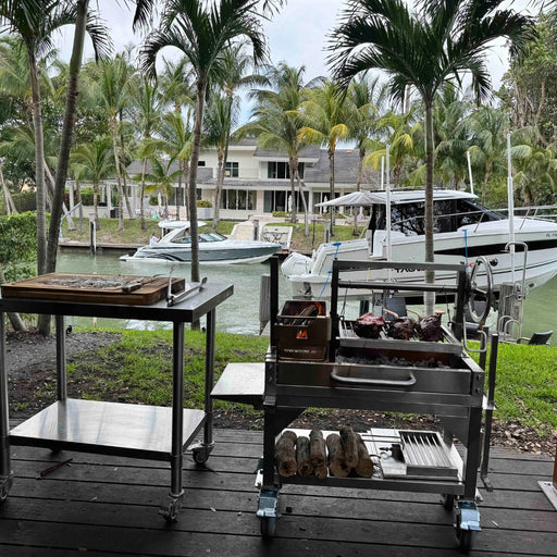 Tagwood BBQ Freestanding Mini Argentine Santa Maria Grill BBQ03SS MINI with stainless steel, adjustable grates, brasero firebox, and peaked roof