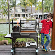 Tagwood BBQ Freestanding Mini Argentine Santa Maria Wood Fire & Charcoal Grill in stainless steel with brasero firebox and adjustable grates.