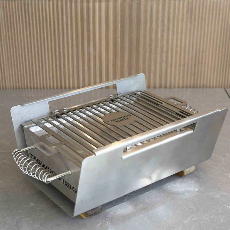 Tagwood BBQ Table Top Warming Brazier BBQ07SS stainless steel warming tray with handles and grill surface for outdoor use.