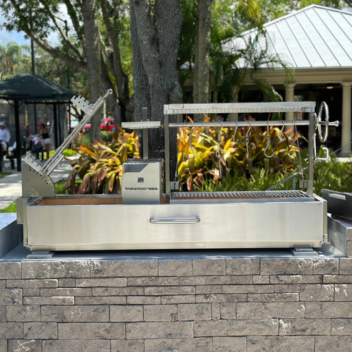 Tagwood BBQ Built-In Santa Maria Argentine wood fire and charcoal grill with stainless steel, height-adjustable grates, and gaucho firebox.