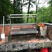Tagwood BBQ Insert Style Argentine Santa Maria Grill with stainless steel, adjustable grates, and gaucho-style brasero firebox in outdoor setting.