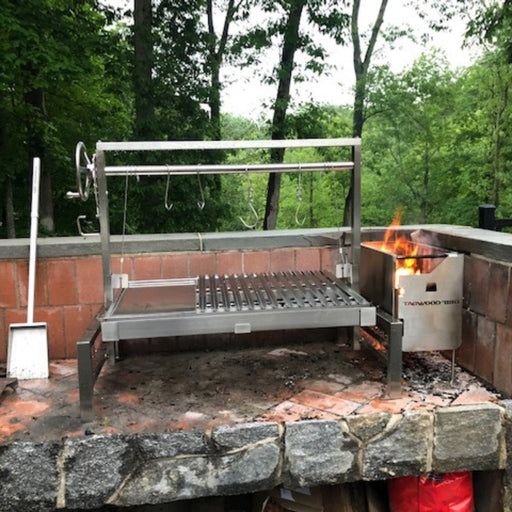 Tagwood BBQ Insert Style Argentine Santa Maria Grill with stainless steel, adjustable grates, and gaucho-style brasero firebox in outdoor setting.
