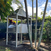 Tagwood BBQ Santa Maria Wood Fire & Charcoal Gaucho Grill BBQ12SS with stainless steel frame, adjustable grates, and brasero firebox outdoors.