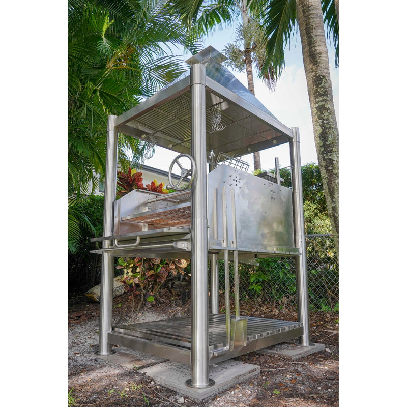 Tagwood BBQ Santa Maria Wood Fire & Charcoal Gaucho Grill BBQ12SS with stainless steel frame, adjustable grates, and brasero firebox outdoors.