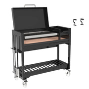 Tagwood BBQ Freestanding Argentine Wood Fire & Charcoal Gaucho Grill BBQ18SI in black steel with height-adjustable grates and peaked roof.