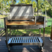 Tagwood BBQ Freestanding Argentine Wood Fire & Charcoal Gaucho Grill BBQ18SS in stainless steel with large cooking area and mobile cart.