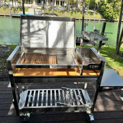 Tagwood BBQ Freestanding Argentine Wood Fire & Charcoal Gaucho Grill BBQ18SS with 304 stainless steel, adjustable grates, and peaked roof.