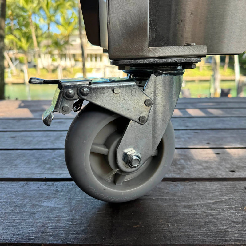 Tagwood BBQ Freestanding Argentine Wood Fire & Charcoal Gaucho Grill - BBQ18SS with sturdy locking caster wheel for easy mobility.